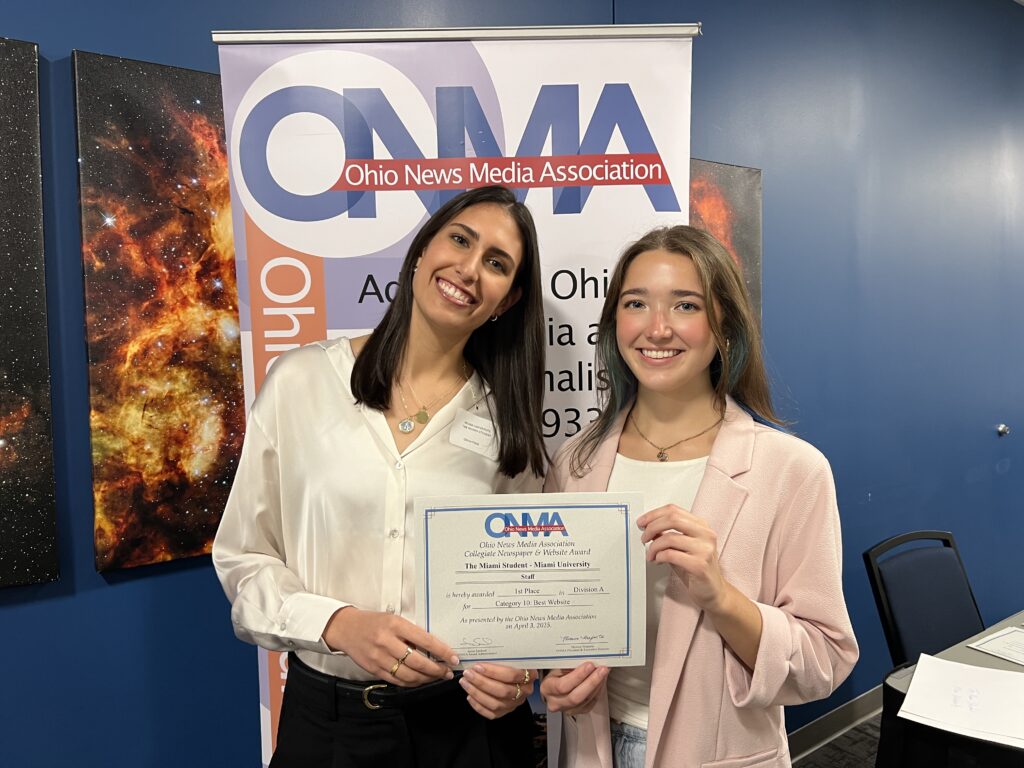 Olivia (left) and Taylor Stumbaugh (right) holding up the Ohio News Media Association (ONMA) Best Website award at the ONMA Fellowship Day on April 3, 2025. Taylor is the campus and community editor at The Miami Student