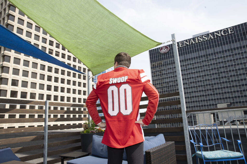 Miami University grad, Michael Gallo showing off his Swoop jersey outside of JPMorganChase in Columbus, Ohio.