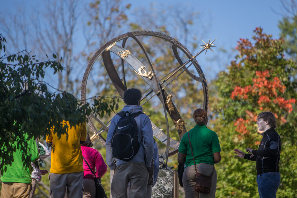 Prospective students enjoying a fall campus tour of Miami University.