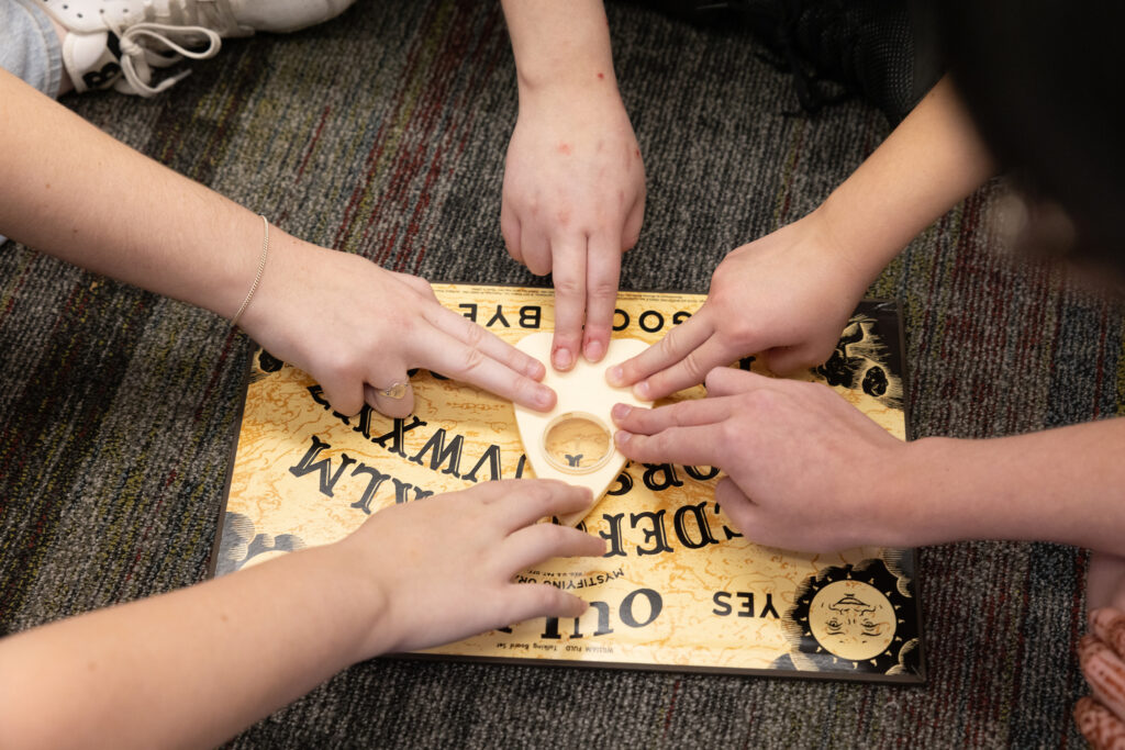 Miami University Anthropology students learning about Oujia board during Investigating the Paranormal course