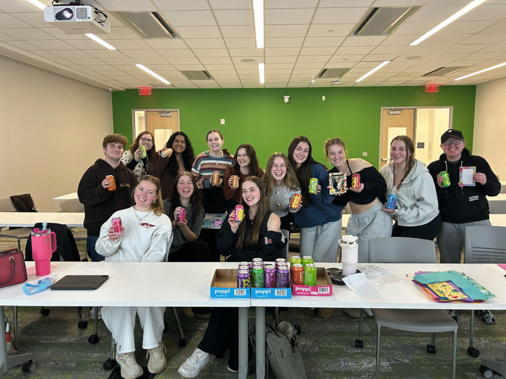 Miami Hope members enjoying Poppi sodas and making picture frames during a club meeting focused on creativity and connection.