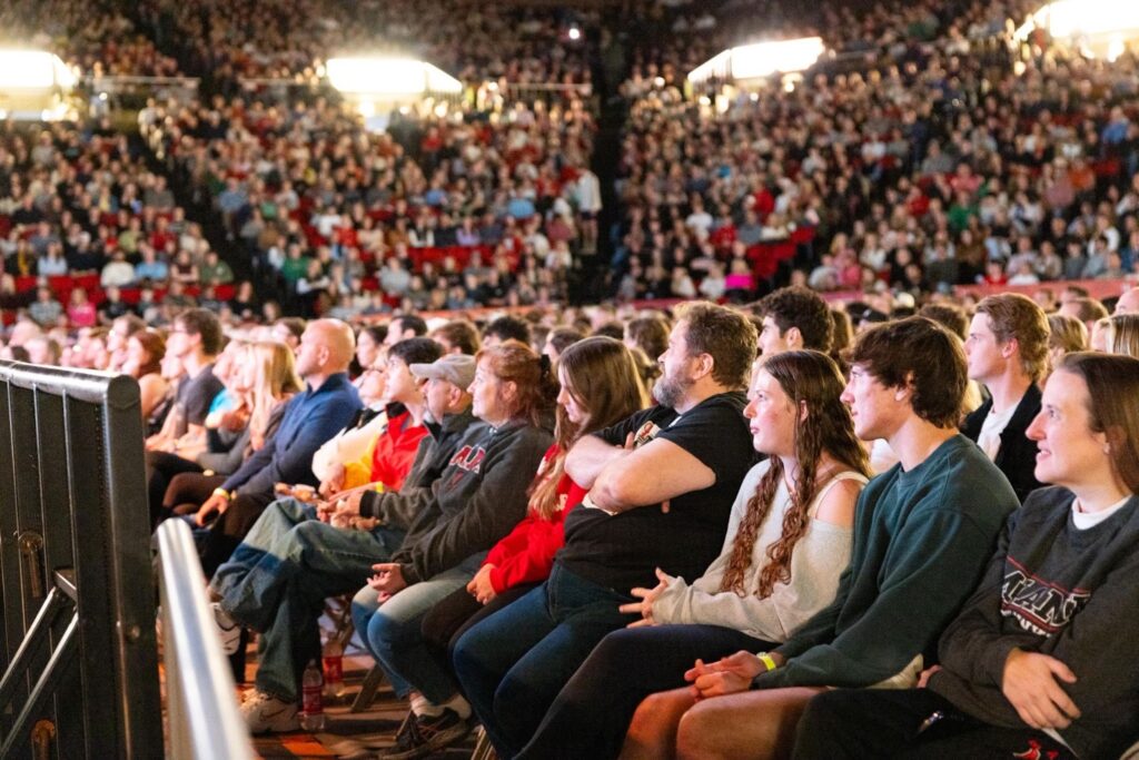 View of students and families watching a stand up comedy show.