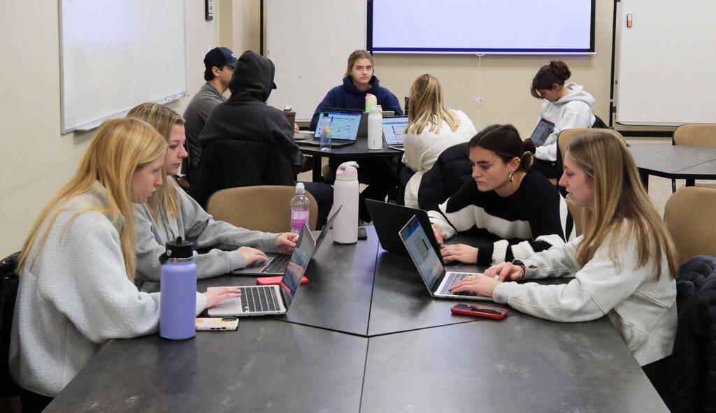 Farmer School of Business capstone group working on their project in class