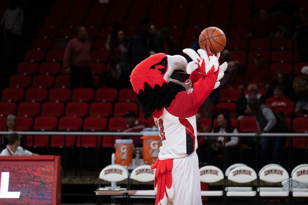 Miami University Swoop practicing his basketball shot ahead of basketball game. 