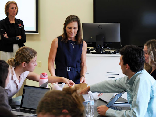 Andrea Watros handing out Spectrum of Sweets cookies to the capstone class.