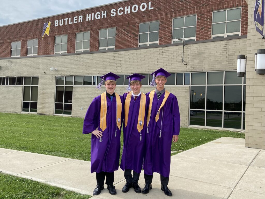 Throwback of triplets Aidan, Nick and Casey Hargett standing in front of Butler High School will also graduate together during Miami University commencement.