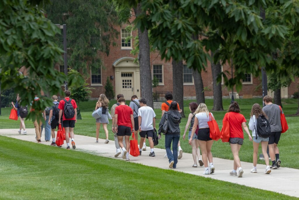 A group of incoming students walking around campus