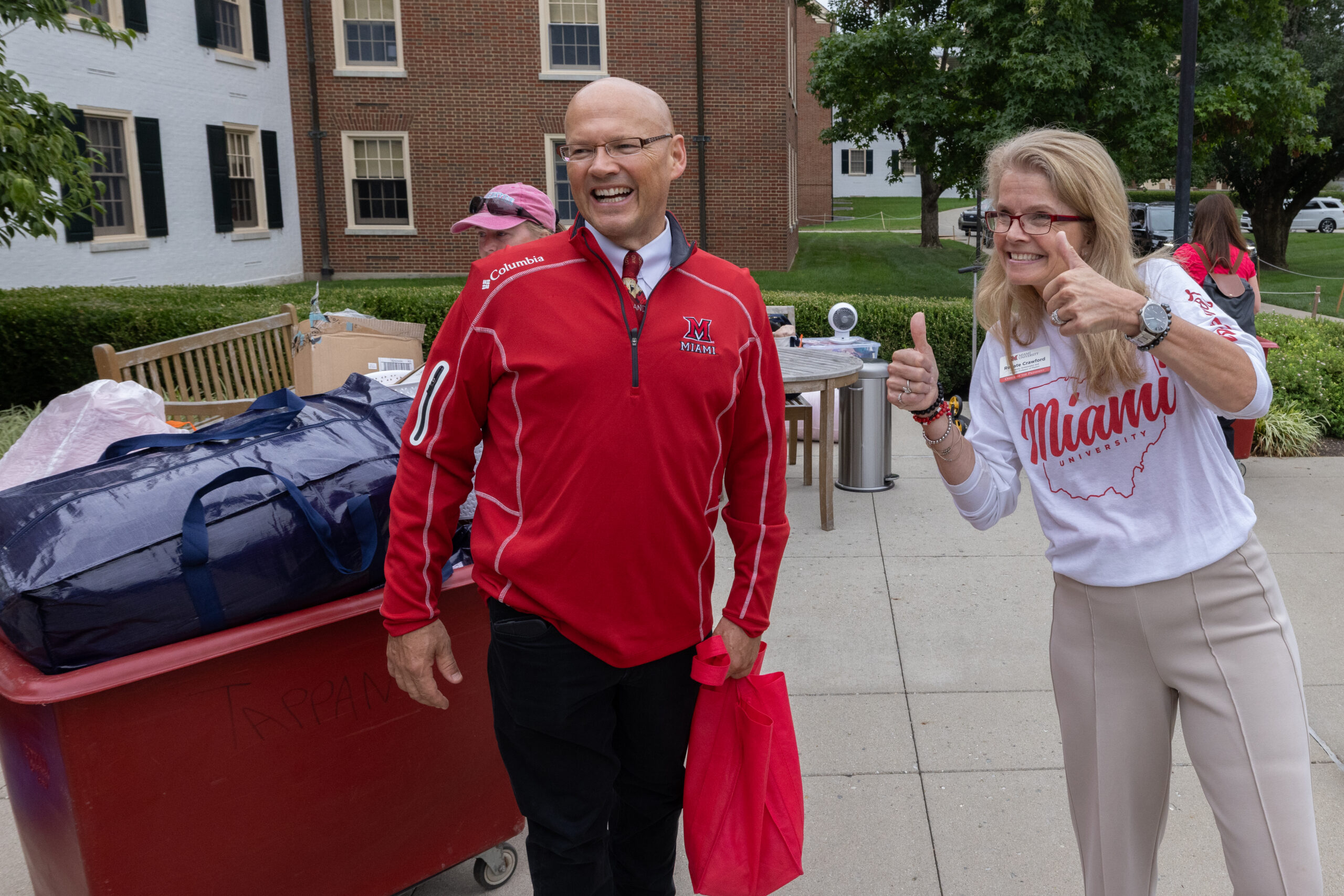 Miami University President and University Ambassador welcoming students during move in.